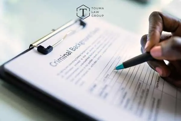 a woman filling out a criminal background check form